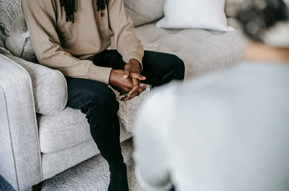 Man sitting on a couch in therapy.