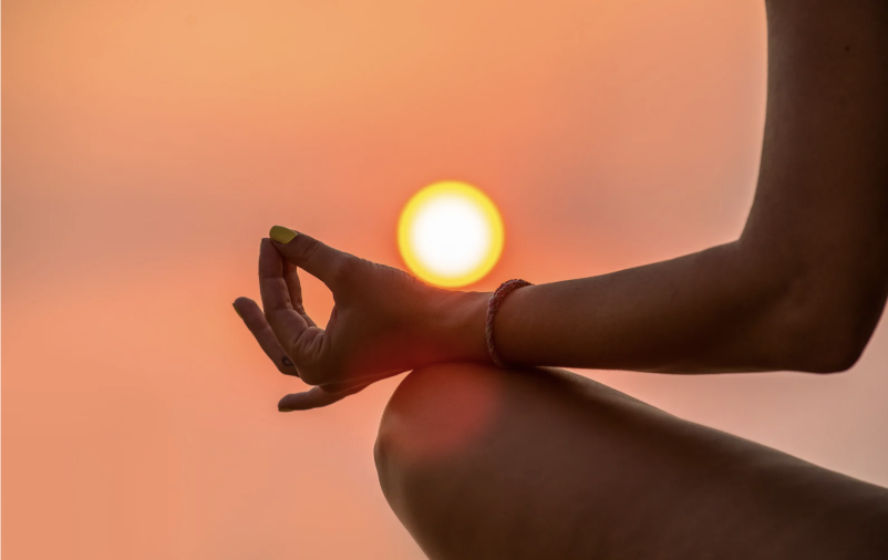 Woman meditating in the sun.