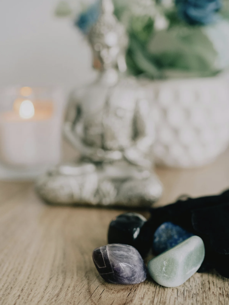 A Buda statue with crystals
