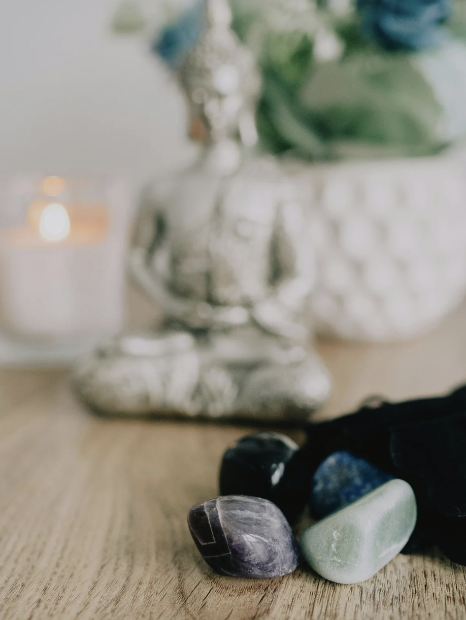 A Buda statue with crystals