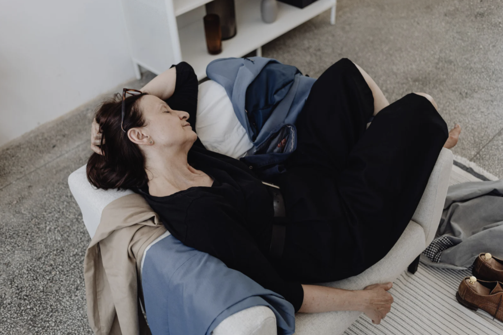 Woman laying exhausted on the couch