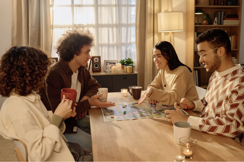 four adults playing a boardgame