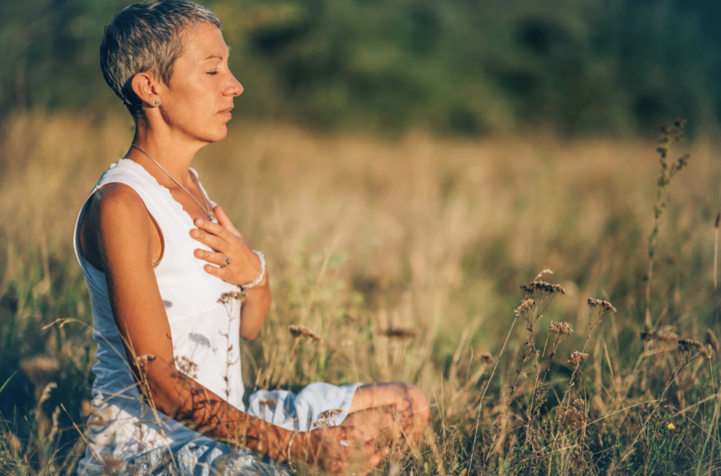Woman meditating in a field