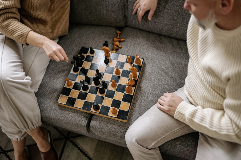 two adults playing chess