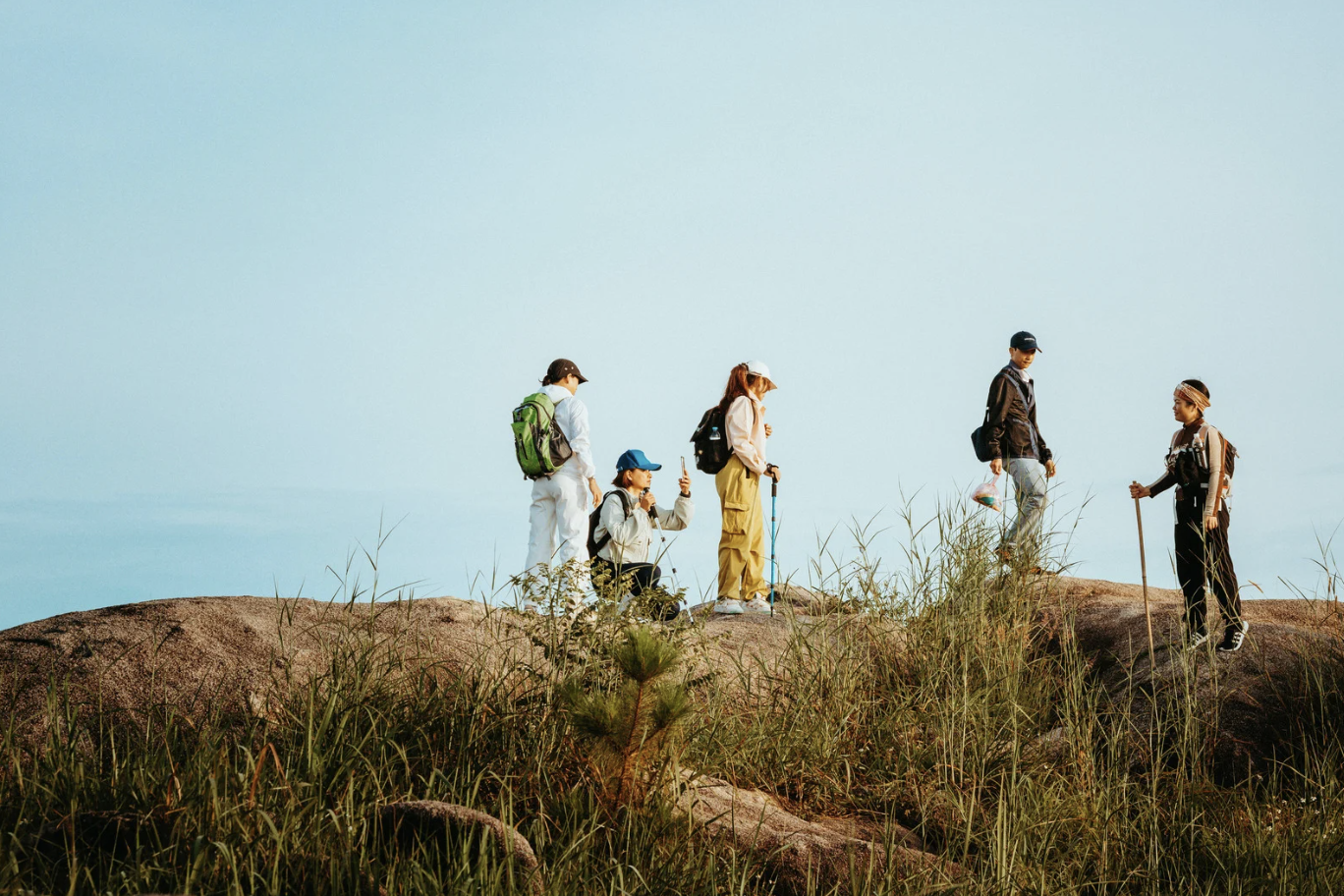 Group of adults looking at something with binoculars
