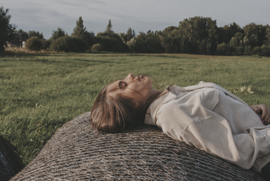 A woman lying in a field relaxing