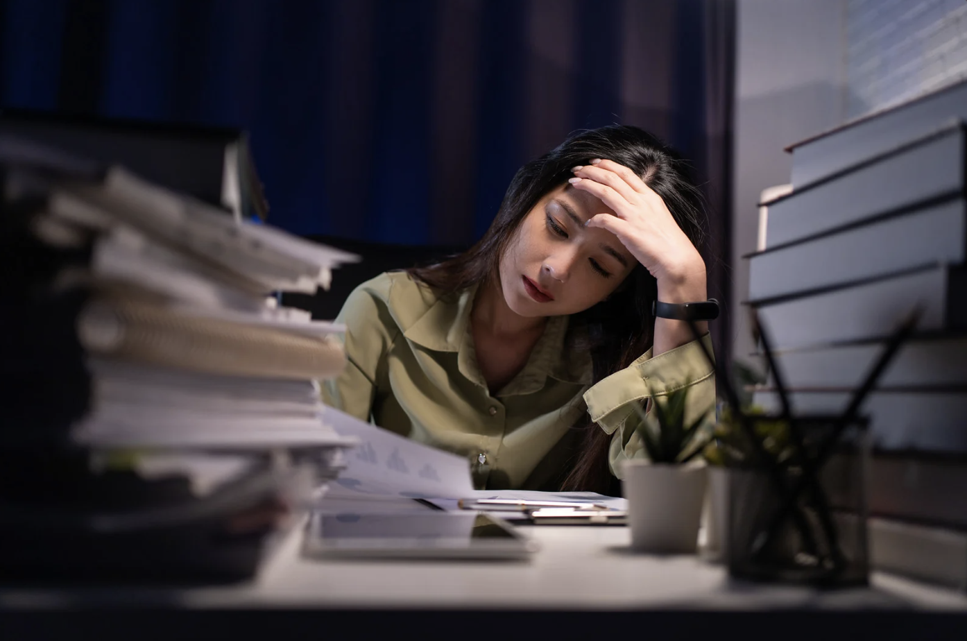 woman stressed at desk at work