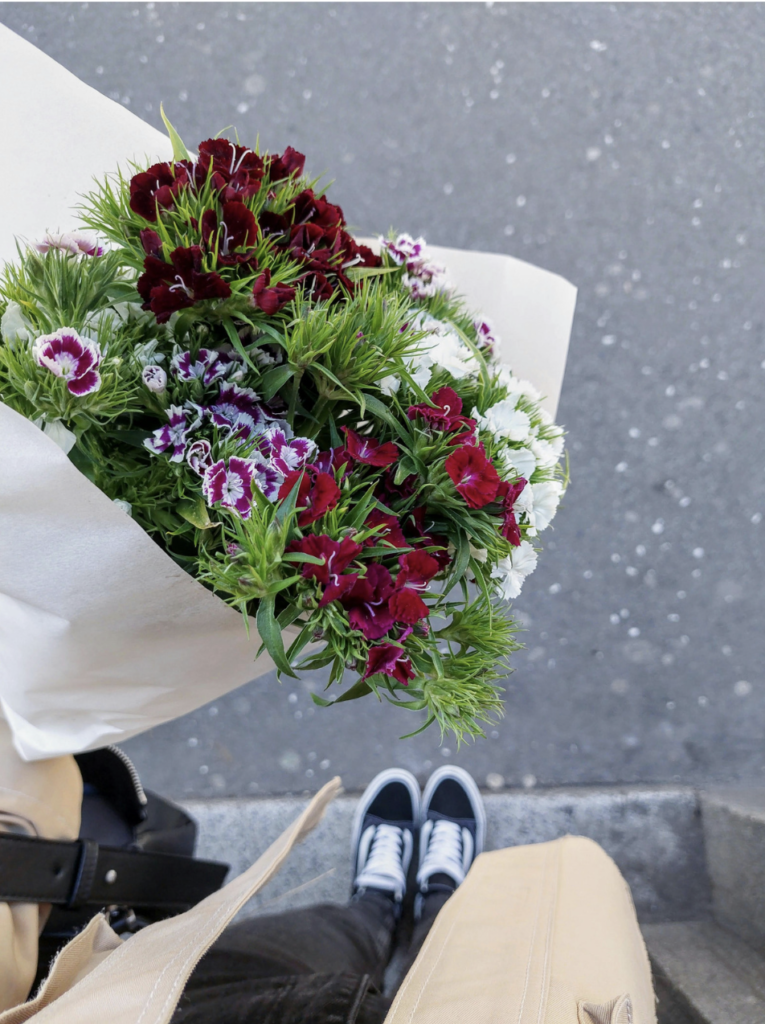 POV woman looking down holding a bouquet
