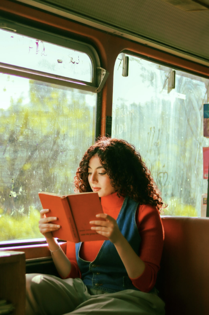 Woman reading on a bright train.