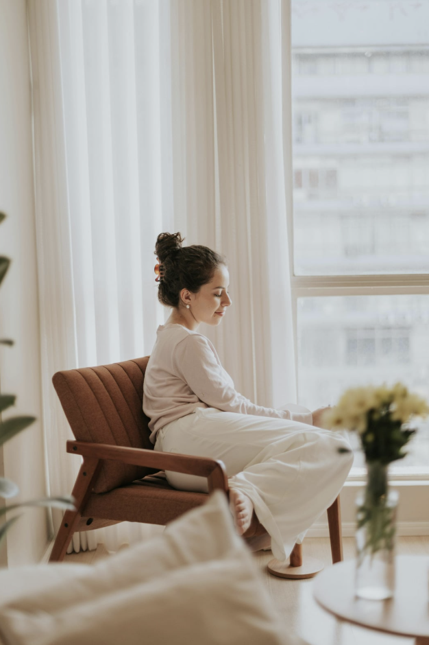 Woman relaxing in a chair in a bright room